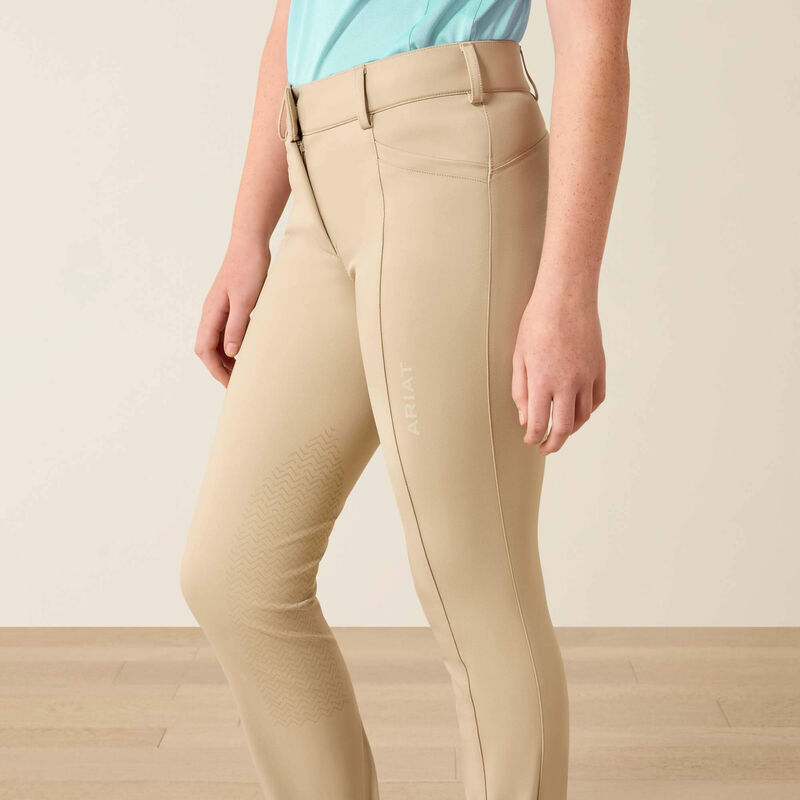 Close up side view of the Ariat Youth Protege Jod Knee Patch Breeches in tan 