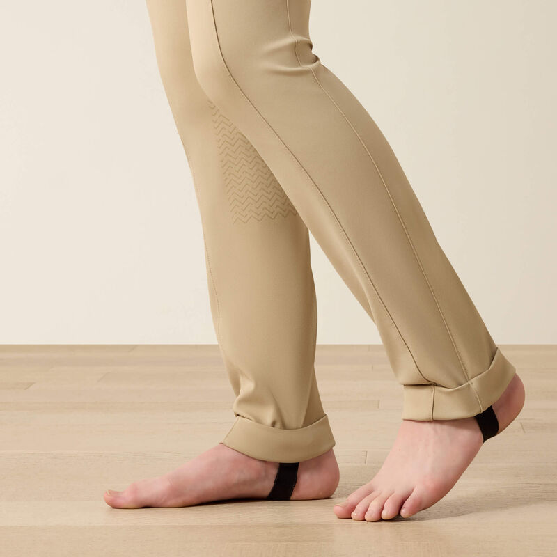 Close up view of the lower leg of the Ariat Youth Protege Jod Knee Patch Breeches in tan 