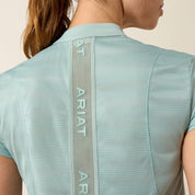 Close-up back view of a model wearing the blue surf Ariat Breathe 1/2 Zip Baselayer on a plain background