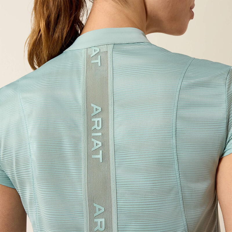 Close-up back view of a model wearing the blue surf Ariat Breathe 1/2 Zip Baselayer on a plain background