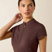 Close-up front view of a model wearing the brown Ariat Breathe 1/2 Zip Baselayer on a plain background