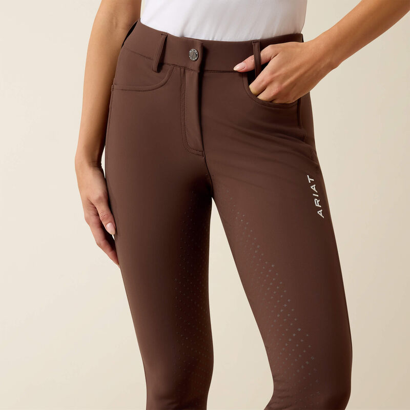 Close-up front view of a model wearing the Ariat Tri Factor NT Full Seat Breech in brown in a studio setting