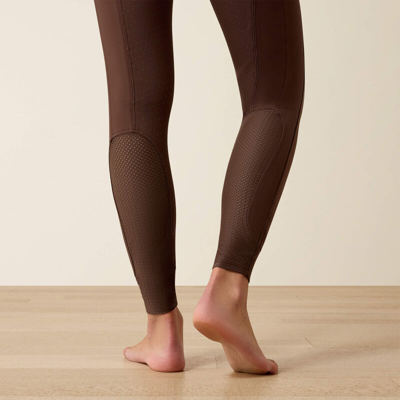 Close-up back view of the lower leg of a model wearing the Ariat Tri Factor NT Full Seat Breech in brown in a studio setting