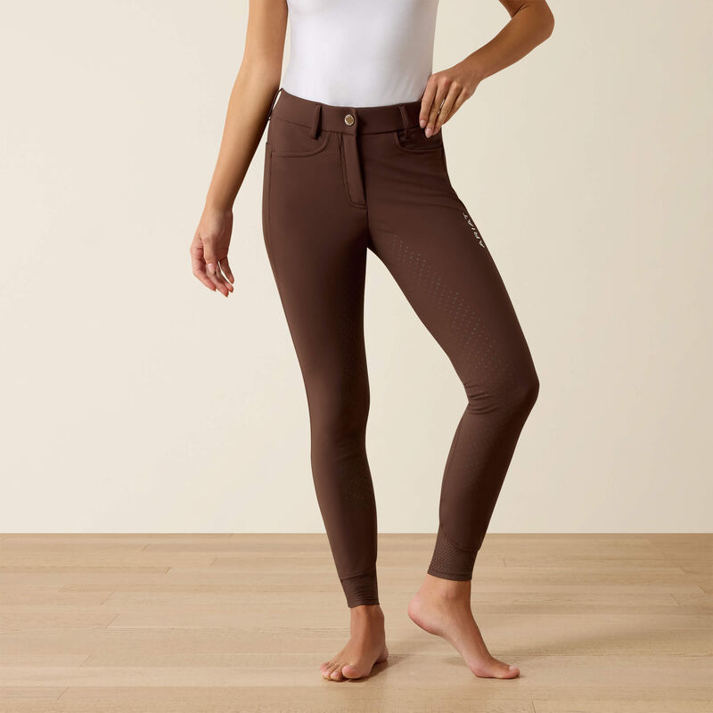 Front view of a model wearing the Ariat Tri Factor NT Full Seat Breech in brown in a studio setting