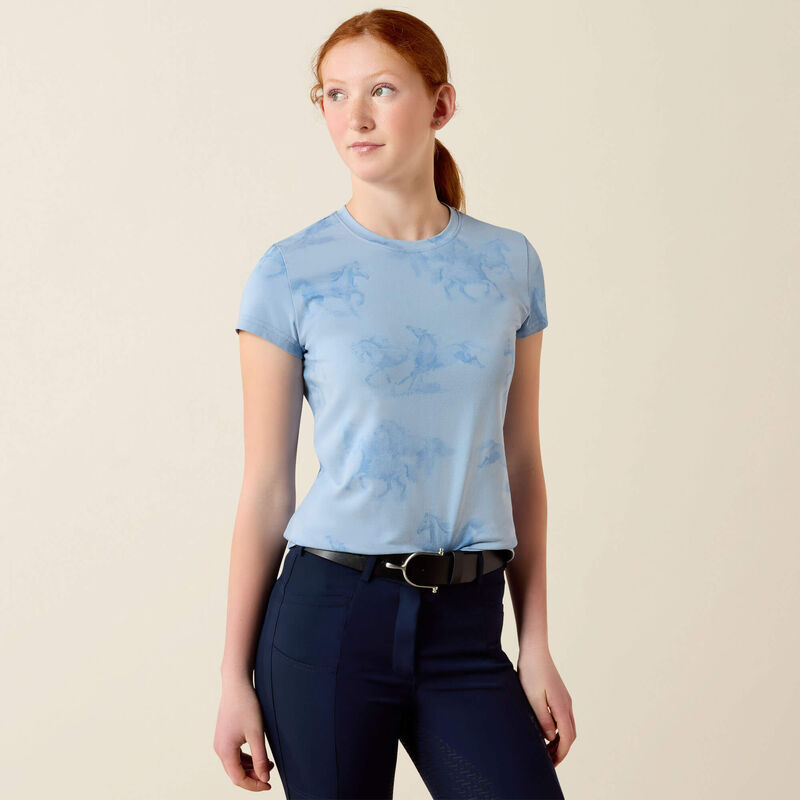 Front view of young girl wearing the Ariat Youth Mirage T-Shirt in blue in a studio setting