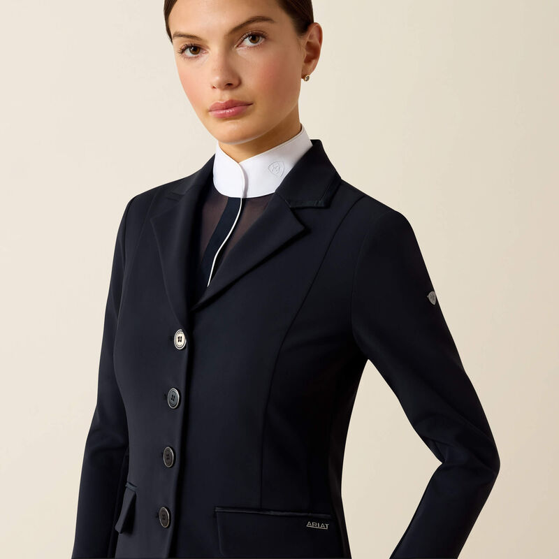 Front view of a female model wearing the Navy Eclipse Ariat Allure Show Coat on a plain background