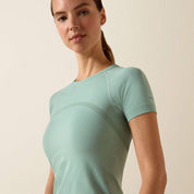 Close up front view of a model wearing the Ariat Sustain Short Sleeve Baselayer in green in a studio