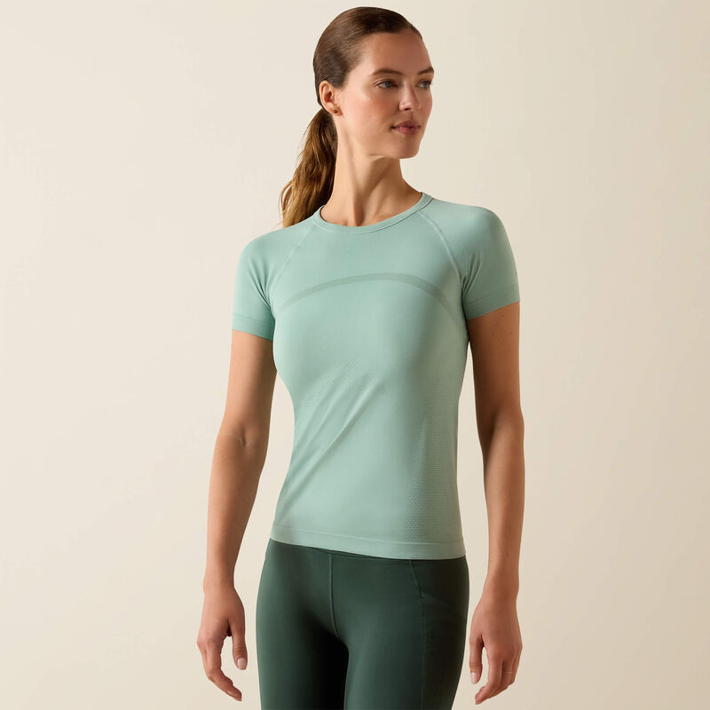 Front view of a model wearing the Ariat Sustain Short Sleeve Baselayer in green in a studio setting