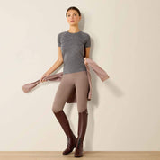 Full front view of a model wearing the Ariat Sustain Short Sleeve Baselayer in gray with brown breeches and tall brown boots in a studio