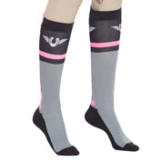 Close-up side view of a model wearing the pink TuffRider Impulsion Knee Hi Socks on a white background