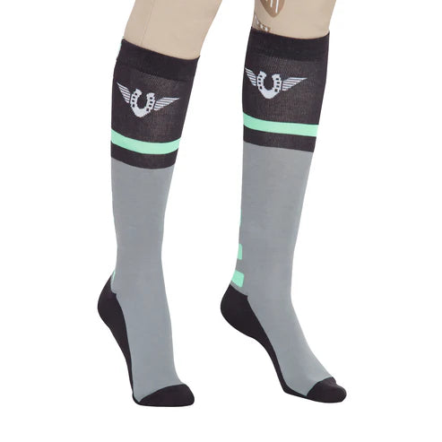 Close-up angled front view of a model wearing the green TuffRider Impulsion Knee Hi Socks on a white background