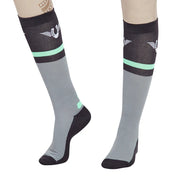 Close-up angled front view of a model wearing the green TuffRider Impulsion Knee Hi Socks on a white background