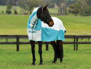 Angled front view of a dark colored horse with head turned wearing the white/mint Weatherbeeta Kool Coat Cotton Airstream II Detach-A-Neck while standing in a grassy pasture