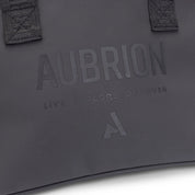 Close-up view of the tone-one-tone Aubrian name with "Live Explore Discover" on the front of the Aubrion React Helmet Bag