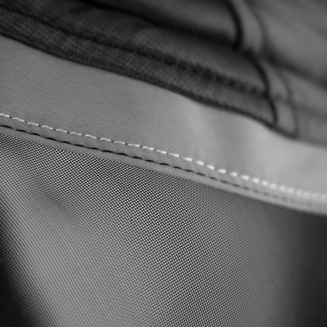 Close-up view of the double stitching on the Shires FlyGuard Pro Fine Mesh Fly Mask with Ears & Open Forelock in black and gray