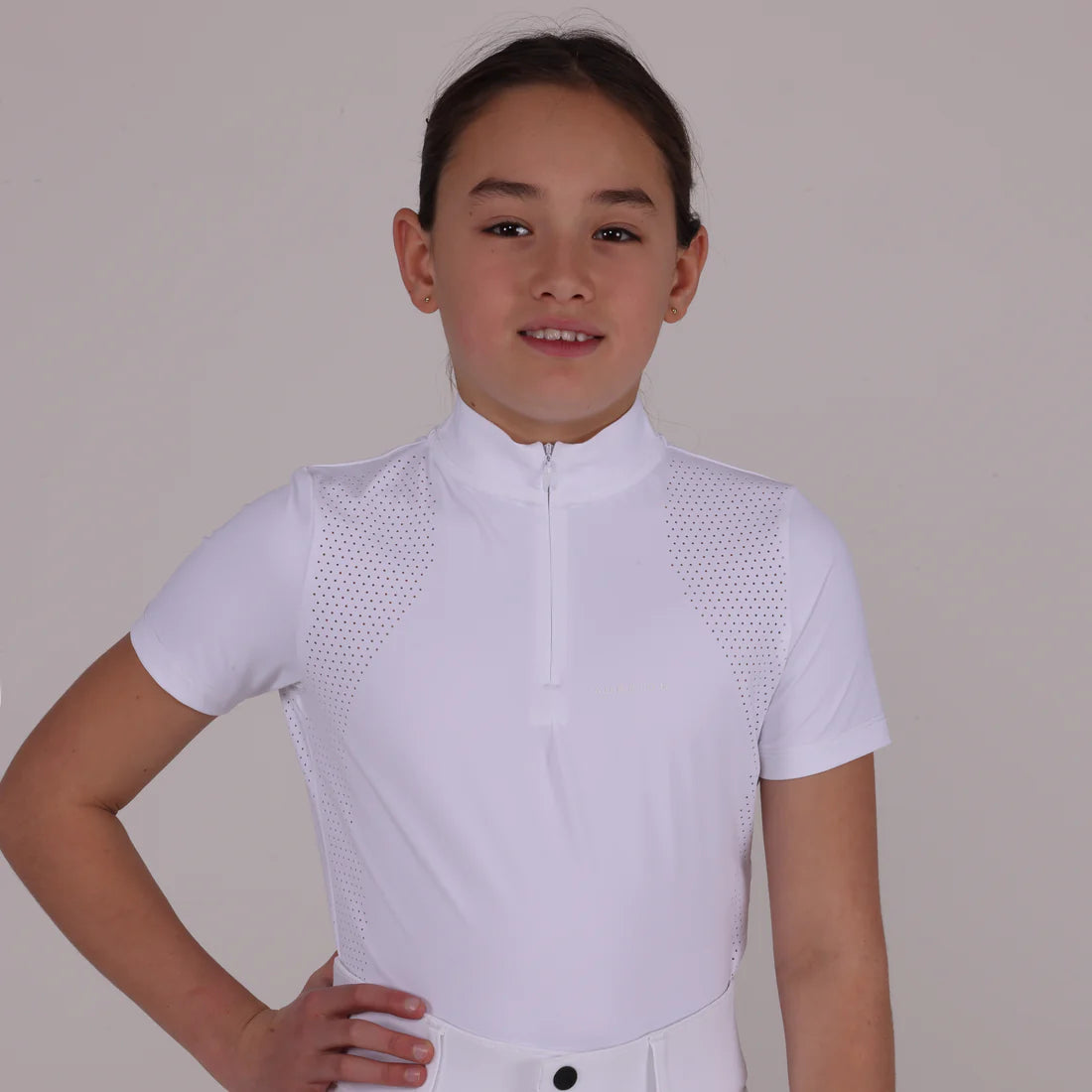 Front view of a young female model wearing the white Aubrion Young Rider Optima GX Show Shirt on a plain background