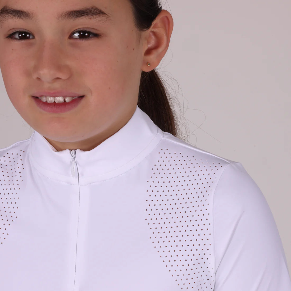 Close-up front veiw of a young female model wearing the white Aubrion Young Rider Optima GX Show Shirt on a plain background