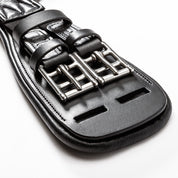 Close-up view of the buckles on the black Kavalkade Soft Casper Short Girth on a white background