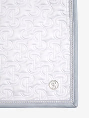 Close-up view of the back corner of the white PS of Sweden Crystal Satin Dressage Saddle Pad on a white background