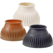 View of a black, a gum, and a white Equi-Essentials Economy Ribbed Bell Boot on a white background