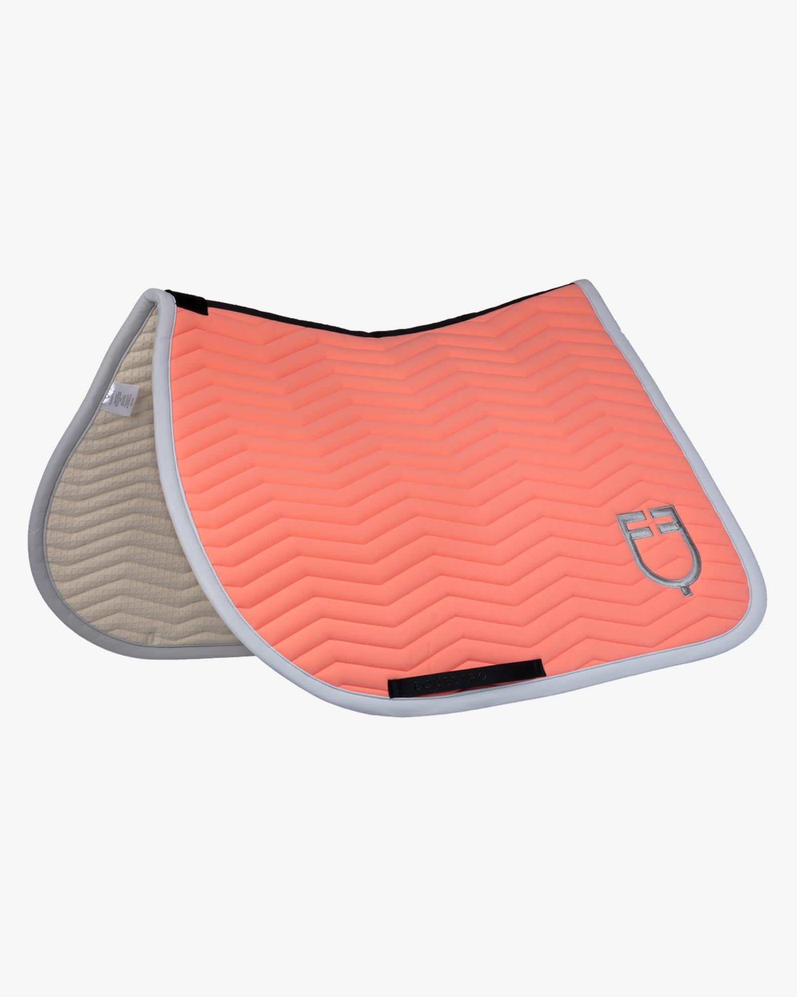 Side angled view of the Equestro Wave Quilting Jumping Saddle Pad In Technical Fabric in a coral color on a white background