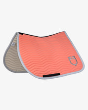 Side angled view of the Equestro Wave Quilting Jumping Saddle Pad In Technical Fabric in a coral color on a white background