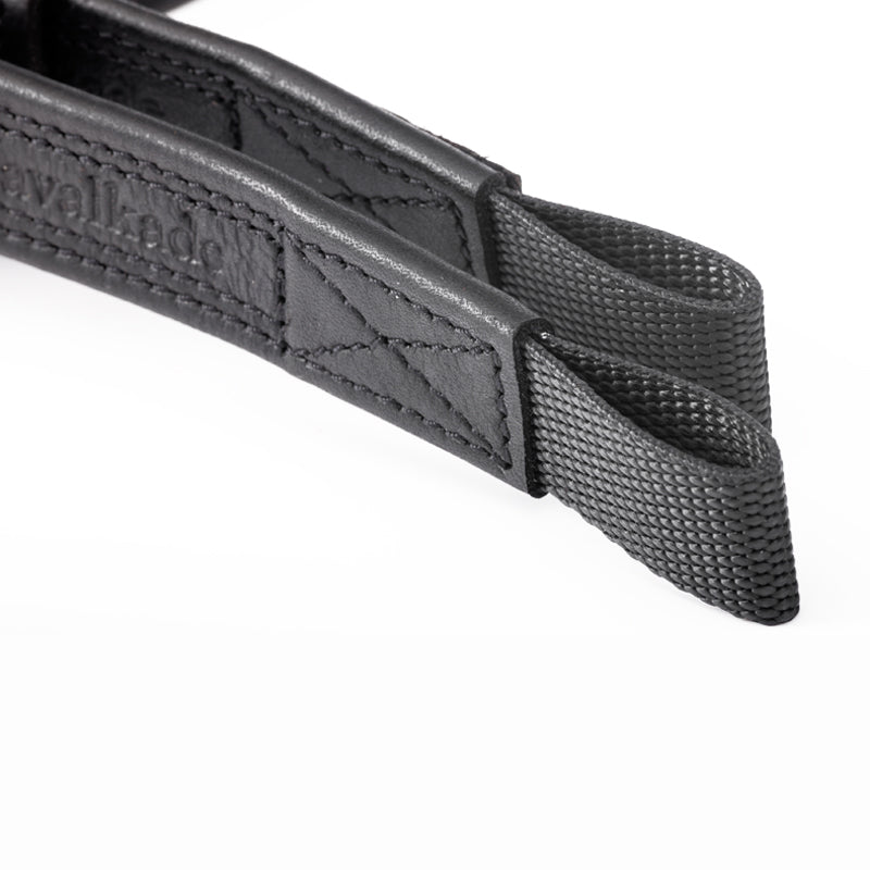 Close-up view of the stirrup bar attachments on the black Kavalkade Oiled Dressage Stirrup Leathers on a white background