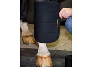 View of someone putting a Back on Track No Bow Leg Wrap on a horse's leg