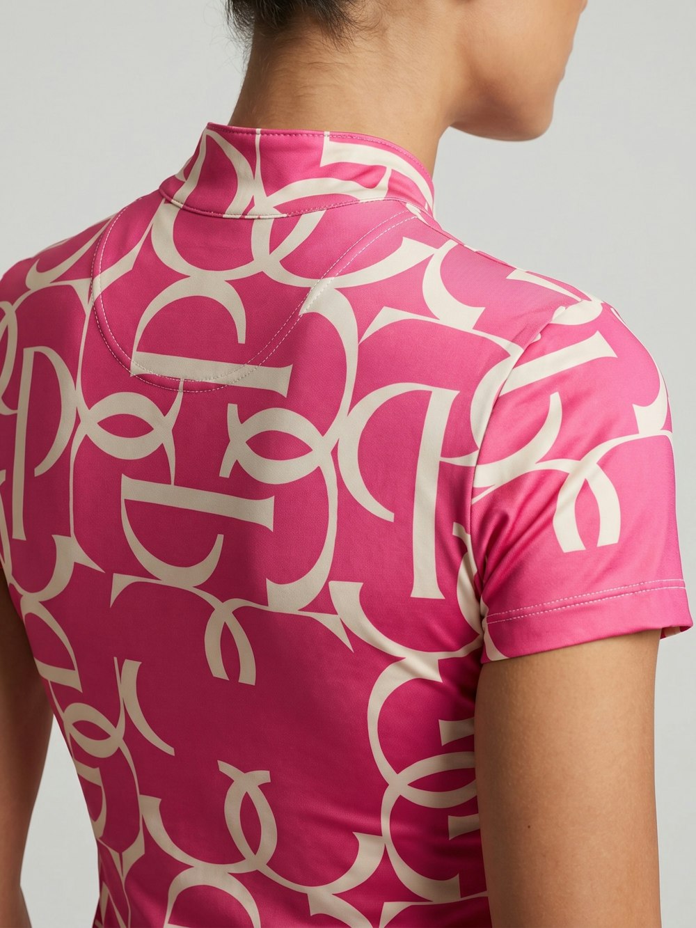 Back view of a model wearing the hot hibiscus PS of Sweden Vera Printed Short Sleeve Top on a plain background