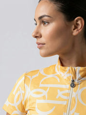 Front view of a model wearing the sunburst sorbet PS of Sweden Vera Printed Short Sleeve Top on a plain background