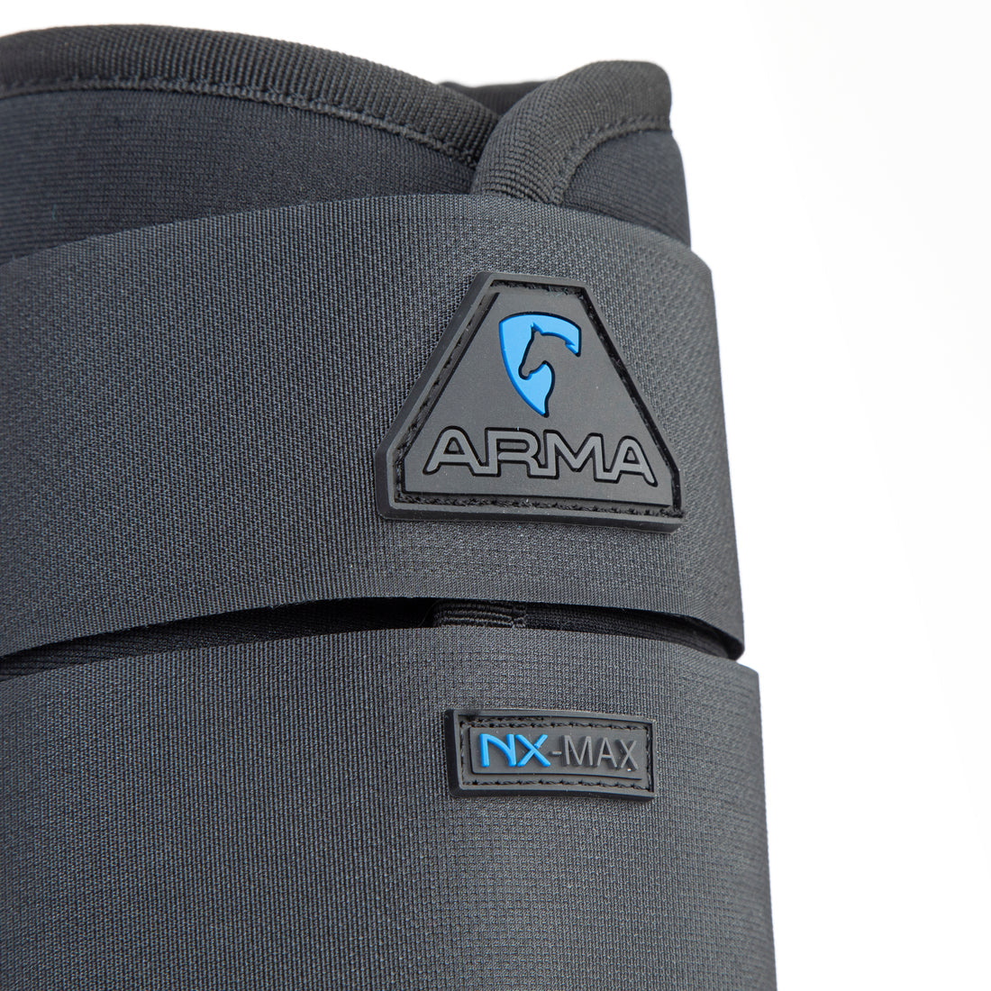 Close-up of Shires Equestrian ARMA NX-MAX brushing boot showing ARMA logo and NX-MAX label