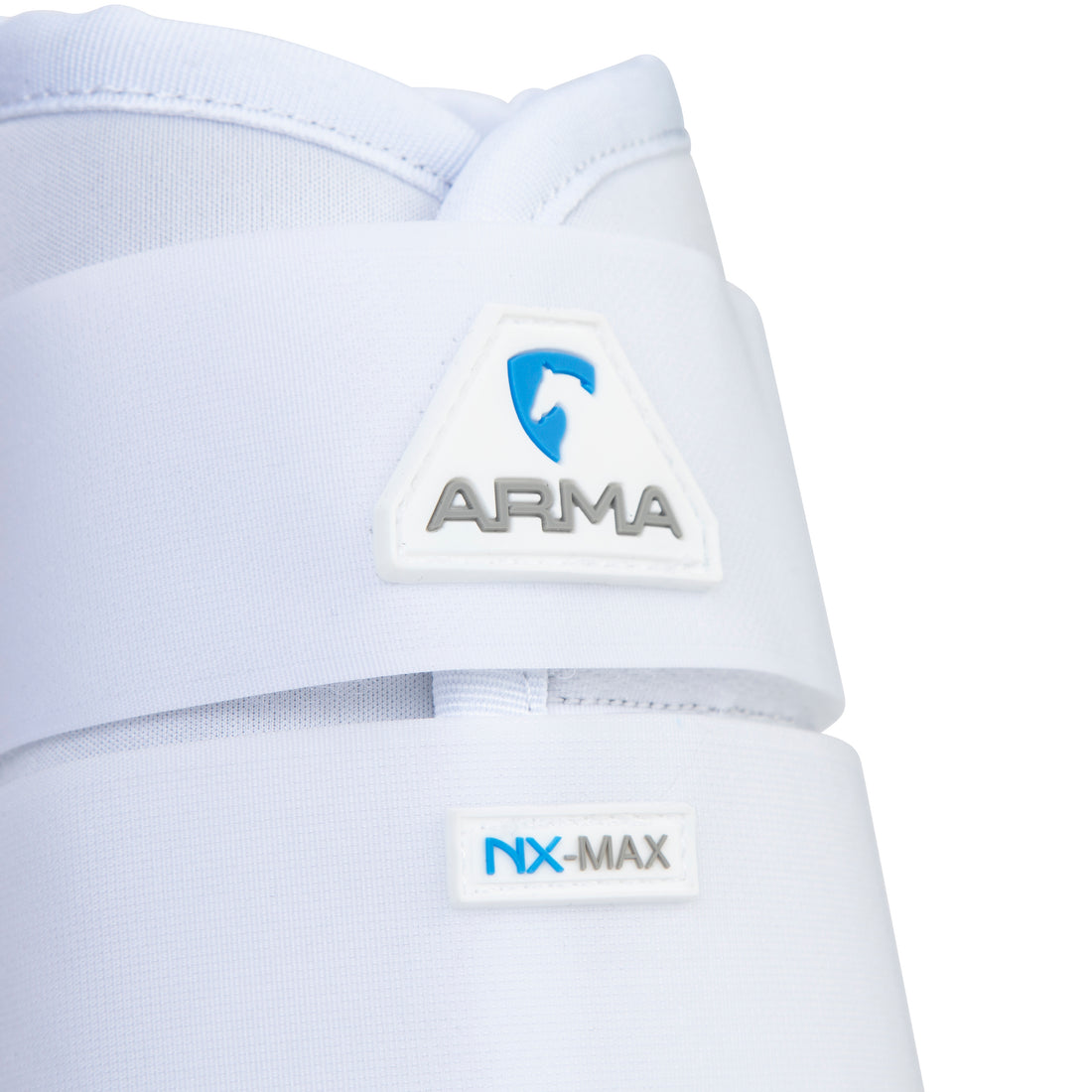 Close-up of Shires Equestrian ARMA NX-MAX brushing boot in white showing ARMA logo and NX-MAX label