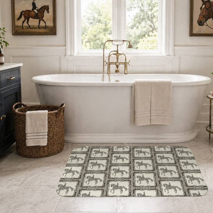 View of the All Designs Equine Dressage Horse Memory Foam Bath Mat on a bathroom floor with a tub in the background