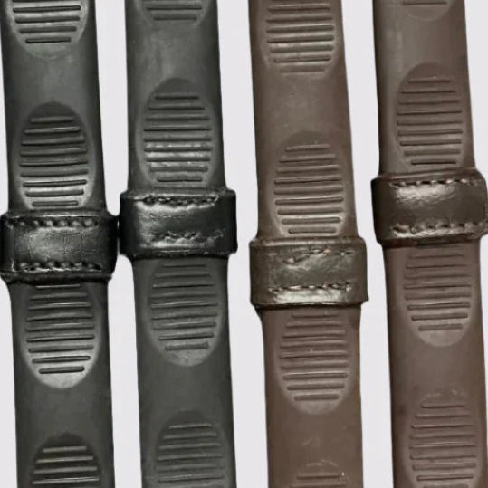 Close-up of a black and brown pair of Correct Connect Thumb Grip Reins on a white background
