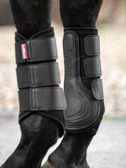 Horse wearing black LeMieux Mesh Brushing Boots standing on pavement