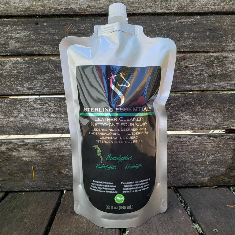 Front view of the 32oz Eucalyptus Sterling Essentials Leather Cleaner with a wood background