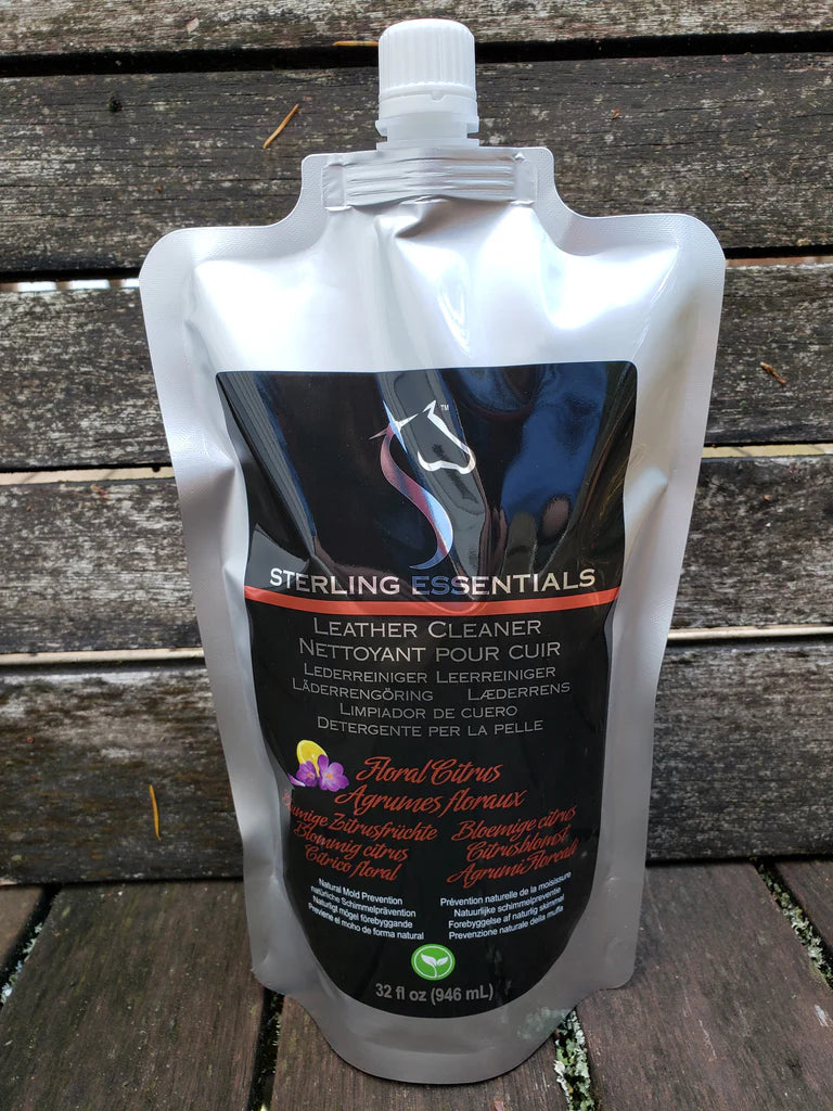 Front view of the 32oz Floral Citrus Sterling Essentials Leather Cleaner with a wood background
