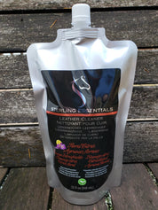 Front view of the 32oz Floral Citrus Sterling Essentials Leather Cleaner with a wood background