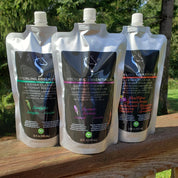 Front view of the 3 different scents of the 32oz Sterling Essentials Leather Cleaner on a wooden railing