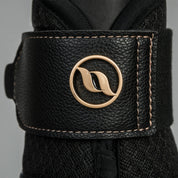 Close-up view of the velcro strap and Back on Track logo on a black Back on Track Deep Nights Brush Boot