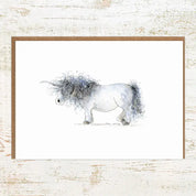 View of the Unicorn Pony Nut Greeting Card on a white washed wood background