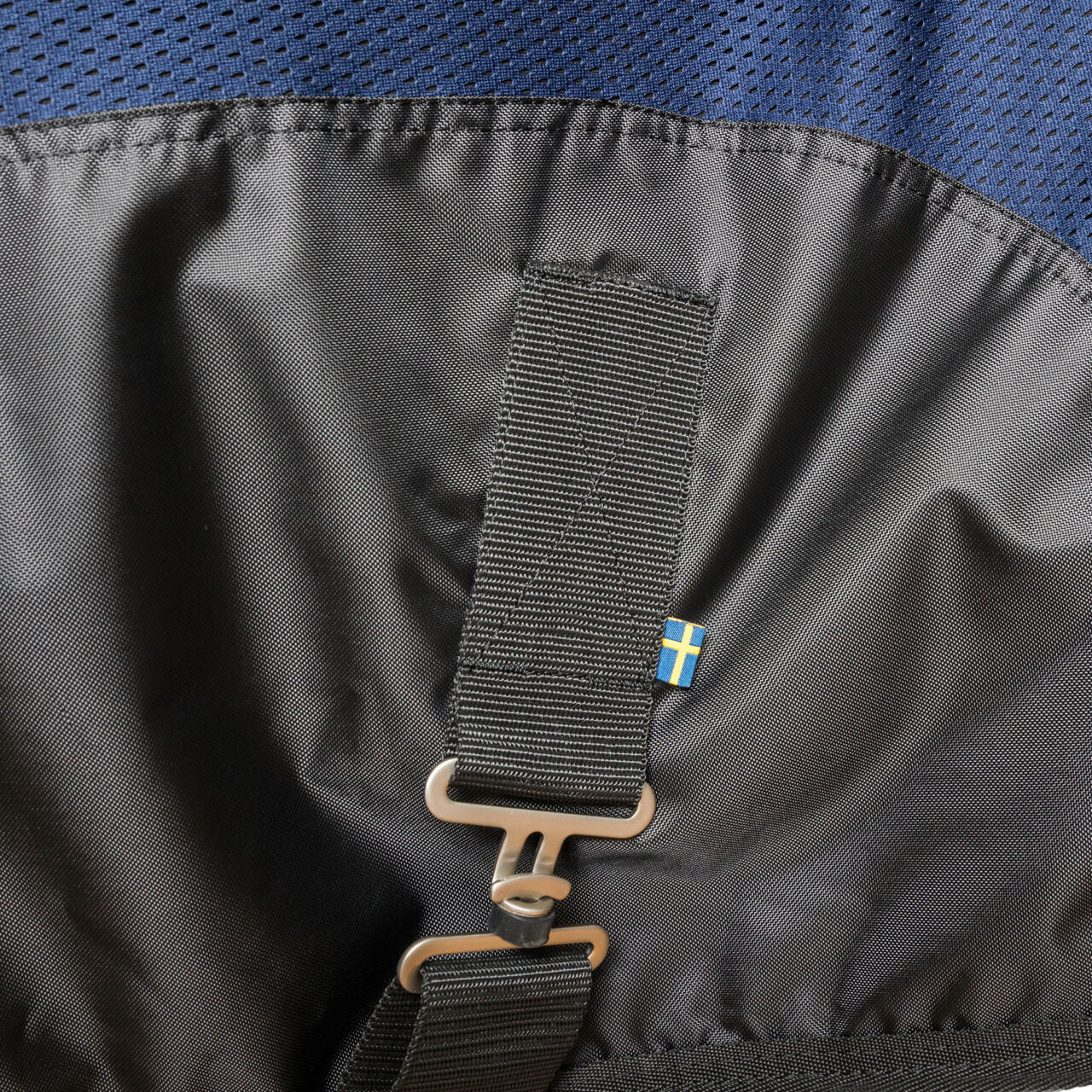 Close-up view of a T-buckle on the navy Back On Track Royal Mesh Sheet Deluxe