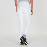 Back view of a model wearing the white Romfh Champion Full Seat Breech and black tennis shoes on a plain background