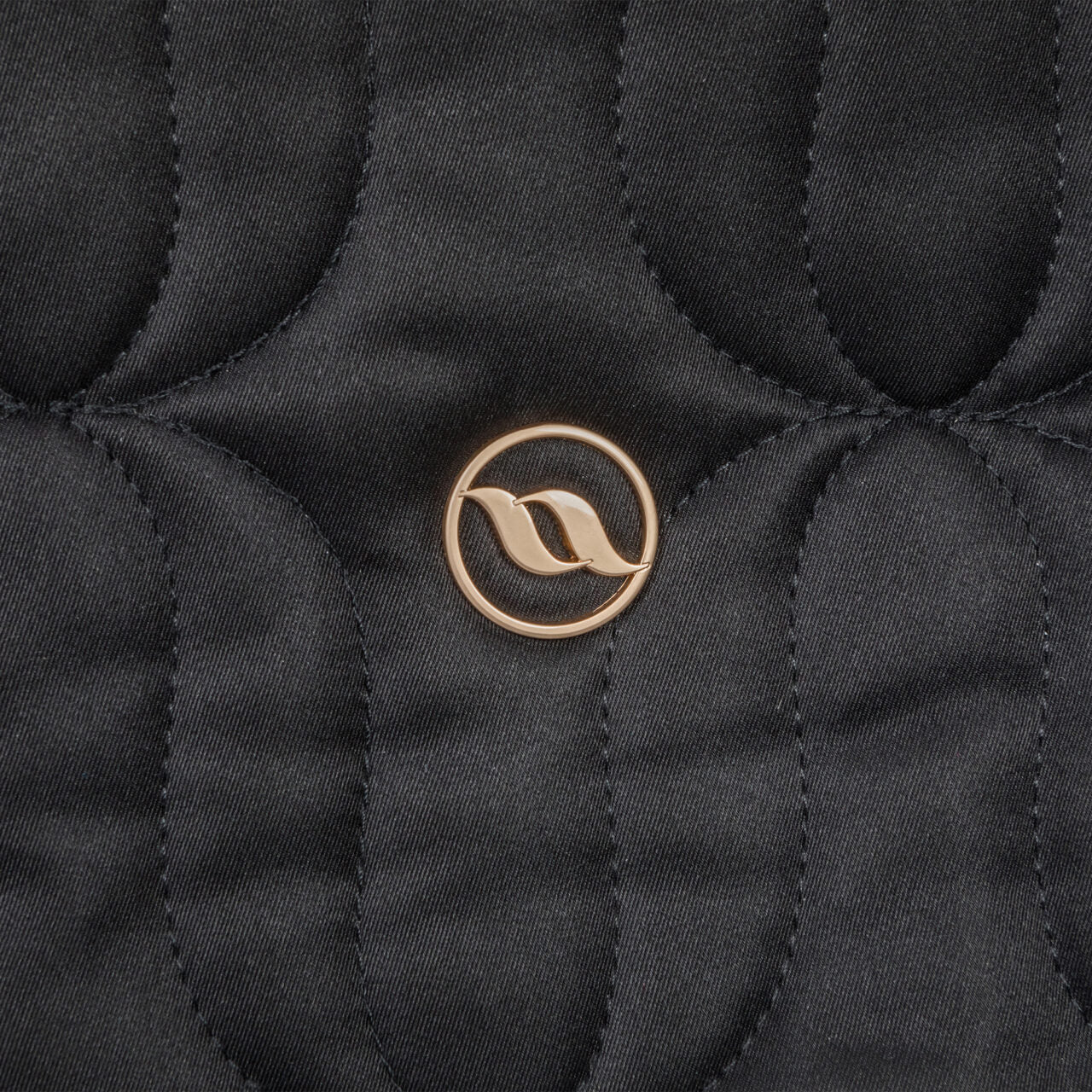 Close-up view of the Back on Track logo on the Back on Track Deep Nights All-Purpose Saddle Pad