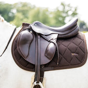 Side view of the brown Back on Track Airflow All-Purpose Saddle Pad under a brown saddle on a gray horse