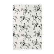 Front view of a folded black & white equestrian Canary Road Kitchen Towel on a white background
