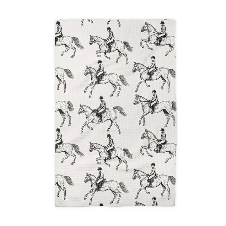 Front view of a folded black & white equestrian Canary Road Kitchen Towel on a white background