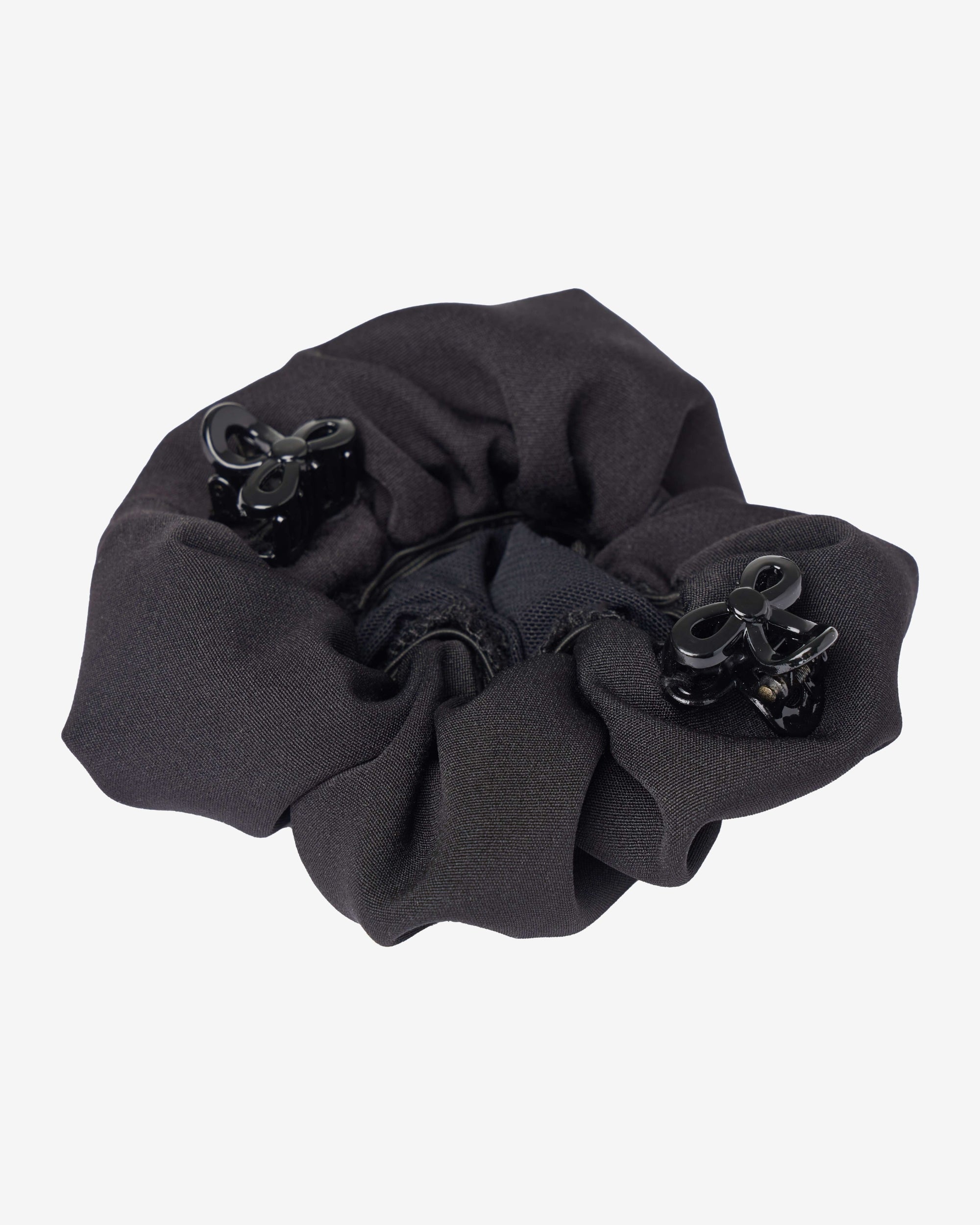Bottom view of the black LeMieux Scrunchie With Crystal Hair Net with clips on a plain background