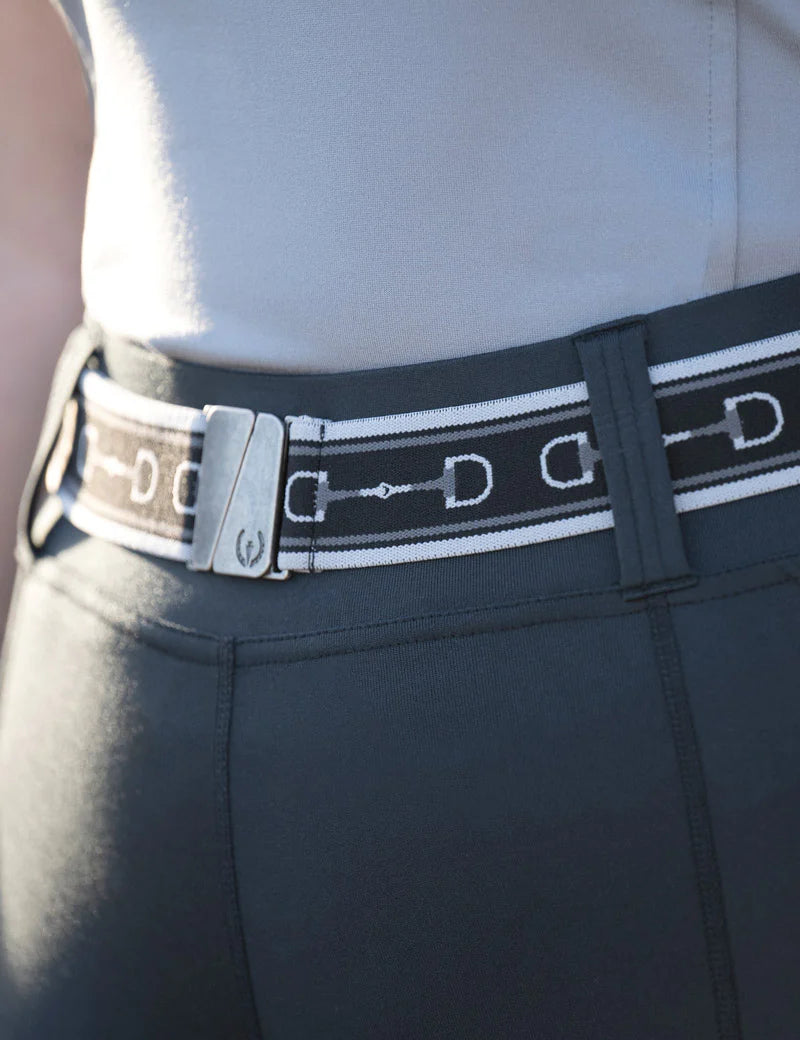 Close-up view of the black Kerrits Kids Snaffle Stretch Belt over gray breeches