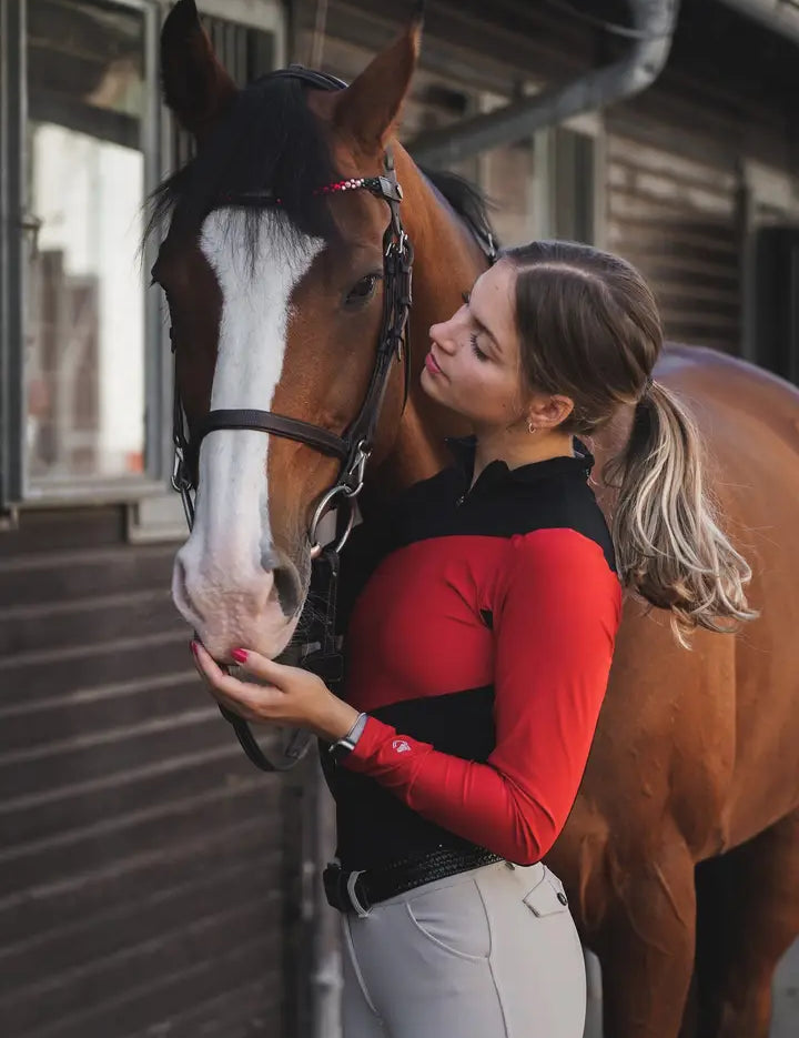red Criniere Sophie Fierce Focus Long Sleeve Shirt with a barn in the background